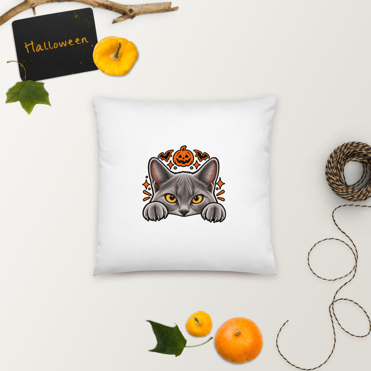 Back of the Uno the Cat Halloween pillow featuring a gray cat peeking over an edge with orange eyes, a jack-o’-lantern, bats, and spooky accents.