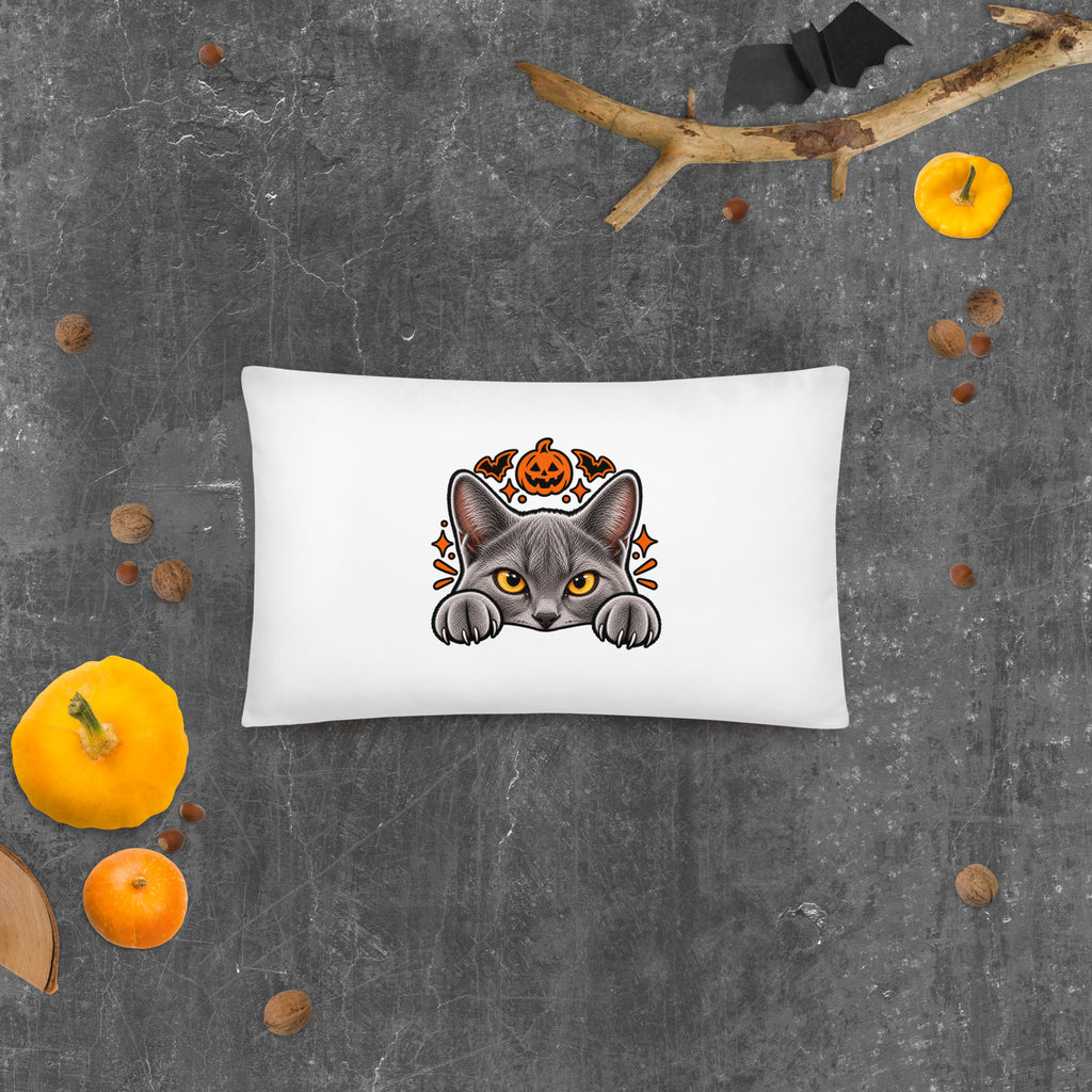 Back of the rectangular Halloween cat pillow featuring Uno peeking over an edge beneath a jack-o’-lantern and orange bats.