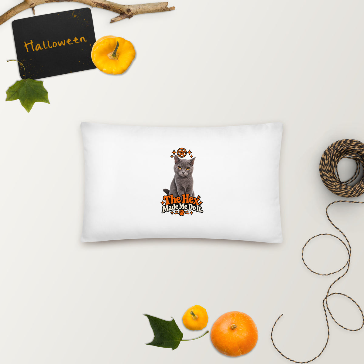 Rectangular white Halloween cat pillow featuring Uno, orange mystical artwork, and “The Hex Made Me Do It” slogan, styled with autumn decorations.
