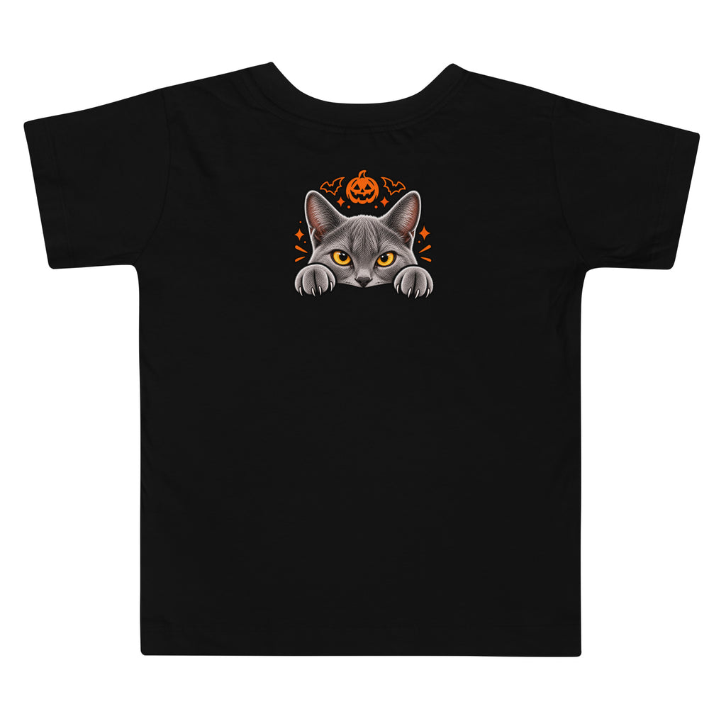 Back of a black toddler Halloween T-shirt featuring Uno the gray cat peeking over an edge beneath an orange jack-o’-lantern and bat accents.