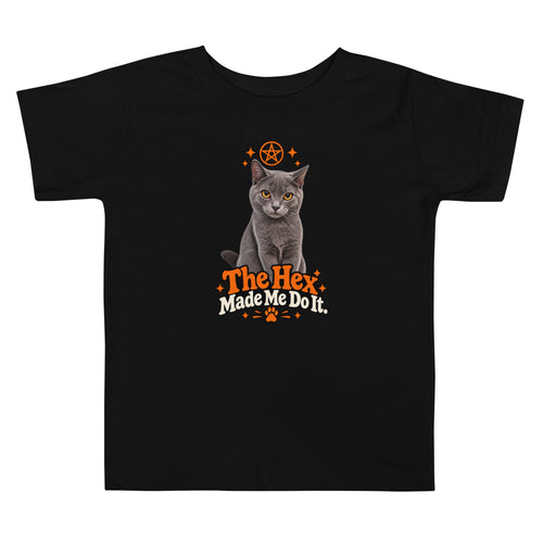 Black toddler Halloween cat T-shirt featuring Uno the gray cat, orange spooky star artwork, and “The Hex Made Me Do It” slogan on the front.