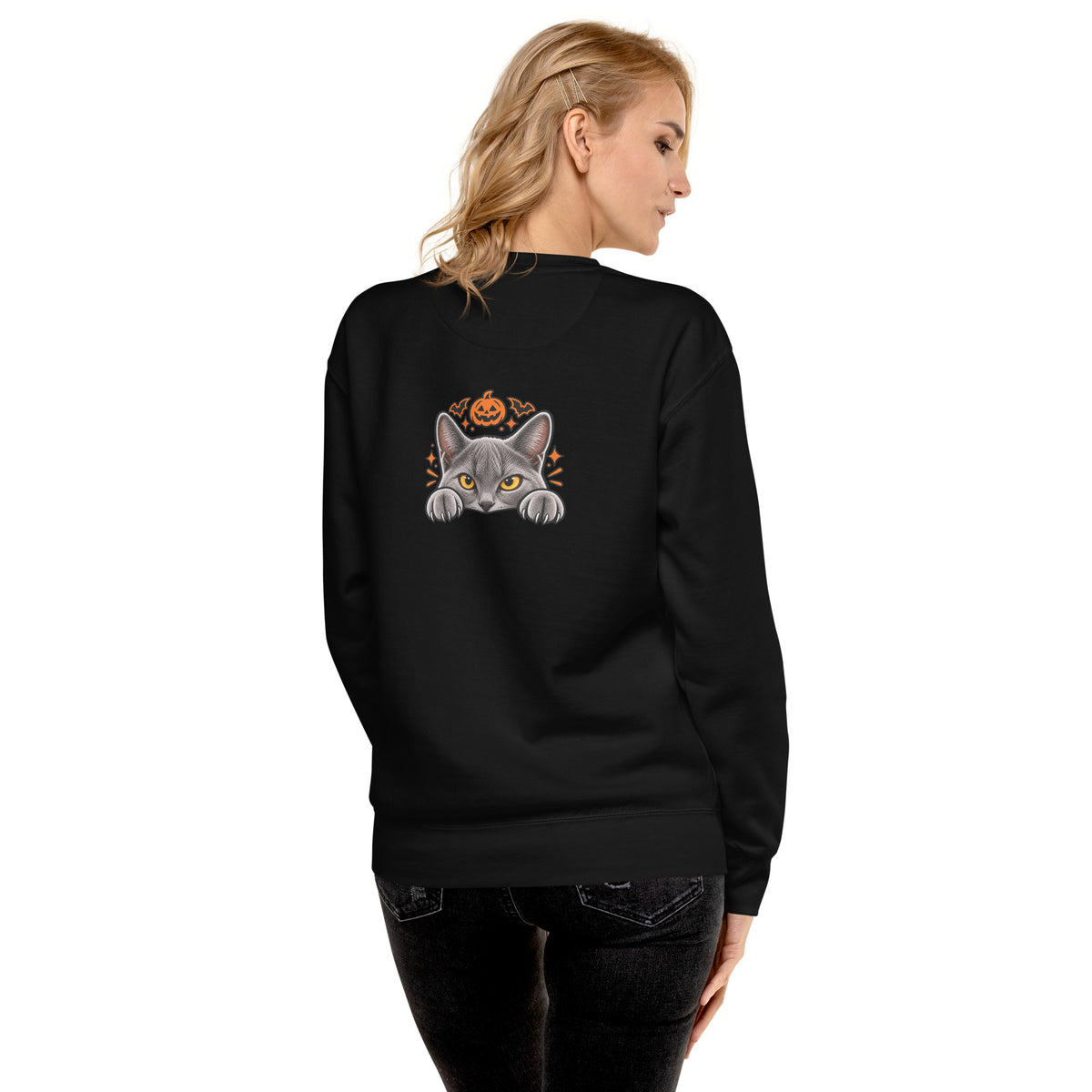 Back of the black Uno the Cat Halloween sweatshirt featuring a gray cat peeking over an edge beneath an orange jack-o'-lantern and Halloween accents.